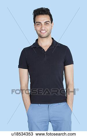 Portrait of a handsome man with hands in pockets over blue background View Large Photo Image Stock Image - Portrait of a handsome man with hands in pockets over blue background. Fotosearch