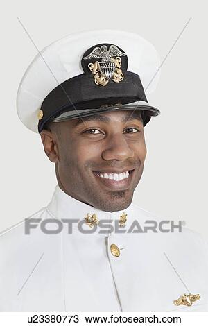 Portrait of a happy young African American US Navy officer over gray background View Large Photo Image Stock Image - Portrait of a happy young African American US Navy officer over gray background. Fotosearch