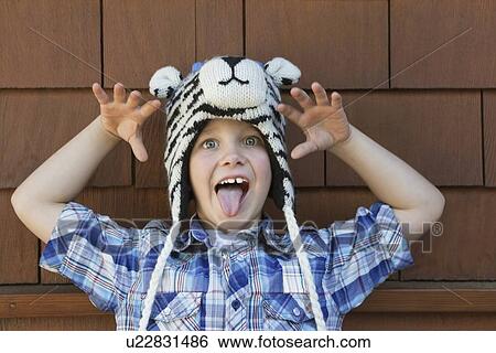 Portrait of a little boy sticking out tongue against brick wall View Large Photo Image Stock Photograph - Portrait of a little boy sticking out tongue against brick wall. Fotosearch
