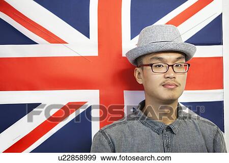 Portrait of a mid adult man against British flag View Large Photo Image Stock Photo - Portrait of a mid adult man against British flag. Fotosearch