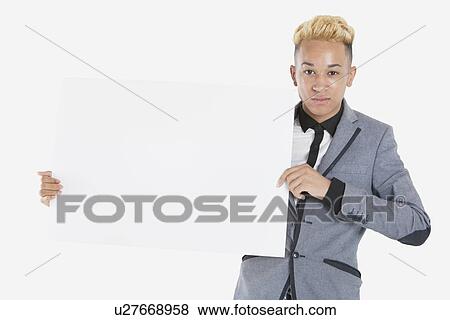 Portrait of a teenage boy holding blank cardboard over gray background View Large Photo Image Stock Photo - Portrait of a teenage boy holding blank cardboard over gray background. Fotosearch