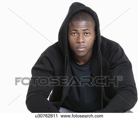 Portrait of a trendy African American man wearing hooded sweatshirt over gray background View Large Photo Image Stock Image - Portrait of a trendy African American man wearing hooded sweatshirt over gray background. Fotosearch