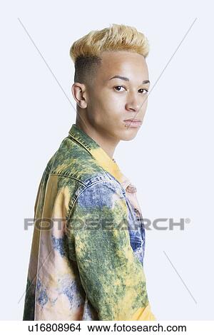 Picture - Portrait of a trendy teenage boy over gray background. Fotosearch