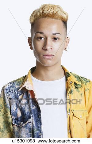 Portrait of a trendy teenage boy with unbuttoned shirt over gray background View Large Photo Image Stock Photo - Portrait of a trendy teenage boy with unbuttoned shirt over gray background. Fotosearch