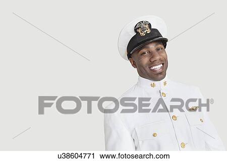 Portrait of a young African American US Navy officer smiling over gray background View Large Photo Image Stock Image - Portrait of a young African American US Navy officer smiling over gray background. Fotosearch