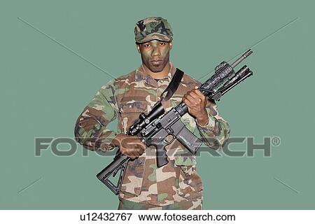 Portrait of a young African American US Marine Corps soldier with M4 assault rifle over green background View Large Photo Image Stock Photo - Portrait of a young African American US Marine Corps soldier with M4 assault rifle over green background. Fotosearch