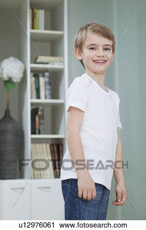 Portrait of a young boy in casuals smiling at home View Large Photo Image Stock Image - Portrait of a young boy in casuals smiling at home. Fotosearch