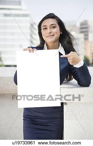 Portrait of a young Indian businesswoman pointing towards Moodboard sign View Large Photo Image Stock Image - Portrait of a young Indian businesswoman pointing towards Moodboard sign. Fotosearch