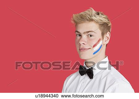 Portrait of a young man with Dutch flag on his face over red background View Large Photo Image Stock Image - Portrait of a young man with Dutch flag on his face over red background. Fotosearch