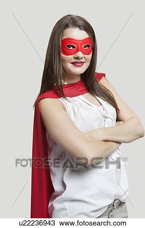 Portrait of a young woman in super hero costume over gray background View Large Photo Image Stock Image - Portrait of a young woman in super hero costume over gray background. Fotosearch