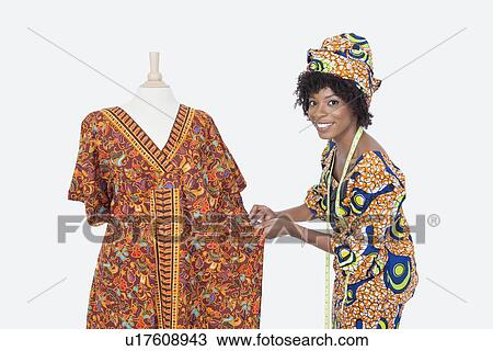 Portrait of an African American female fashion designer working on dashiki over gray background View Large Photo Image Stock Image - Portrait of an African American female fashion designer working on dashiki over gray background. Fotosearch