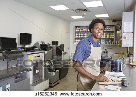 Stock Photography - Portrait of an African American male at paint section in super market. Fotosearch