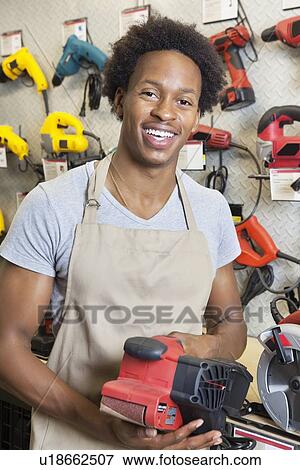 Portrait of an African American male store clerk holding electronic tool View Large Photo Image Stock Photo - Portrait of an African American male store clerk holding electronic tool. Fotosearch