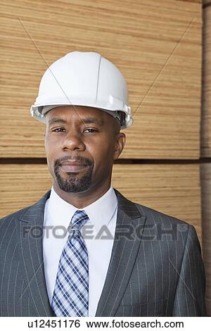 Portrait of an African American male engineer with wooden planks in background View Large Photo Image Stock Photograph - Portrait of an African American male engineer with wooden planks in background. Fotosearch