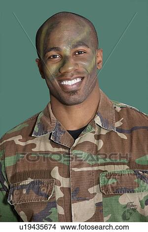 Portrait of an African American male US Marine Corps soldier with camouflaged face over green background View Large Photo Image Picture - Portrait of an African American male US Marine Corps soldier with camouflaged face over green background. Fotosearch