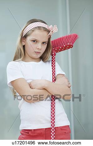 Portrait of an angry girl with broom View Large Photo Image Stock Photograph - Portrait of an angry girl with broom. Fotosearch