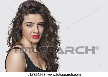 Portrait of an attractive young woman against gray background View Large Photo Image Stock Image - Portrait of an attractive young woman against gray background. Fotosearch