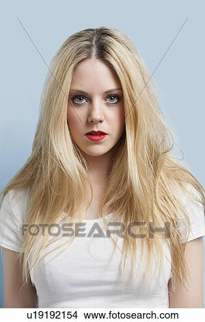 Portrait of attractive young blond woman with red lips against light blue background View Large Photo Image Picture - Portrait of attractive young blond woman with red lips against light blue background. Fotosearch