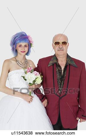 Portrait of beautiful young bride standing arm in arm with father View Large Photo Image Stock Photo - Portrait of beautiful young bride standing arm in arm with father. Fotosearch