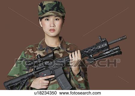Portrait of beautiful young US Marine Corps soldier with M4 assault rifle over brown background View Large Photo Image Stock Image - Portrait of beautiful young US Marine Corps soldier with M4 assault rifle over brown background. Fotosearch