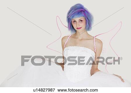 Portrait of beautiful young woman dressed as angel with dyed hair against gray background View Large Photo Image Stock Photo - Portrait of beautiful young woman dressed as angel with dyed hair against gray background. Fotosearch
