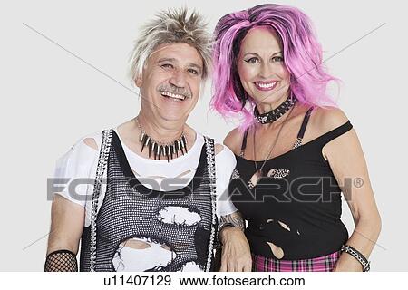 Portrait of cheerful senior punk couple with arm in arm over gray background View Large Photo Image Stock Photo - Portrait of cheerful senior punk couple with arm in arm over gray background. Fotosearch