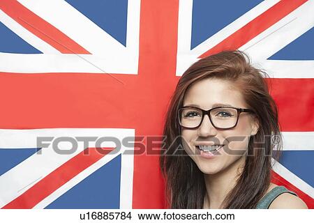 Portrait of cheerful young woman wearing eyeglasses against British flag View Large Photo Image Picture - Portrait of cheerful young woman wearing eyeglasses against British flag. Fotosearch
