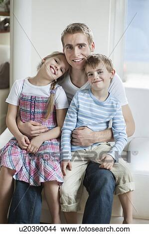 Picture - Portrait of children sitting on father's laps. Fotosearch