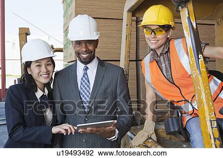 Portrait of engineers and female industrial worker smiling View Large Photo Image Stock Image - Portrait of engineers and female industrial worker smiling. Fotosearch