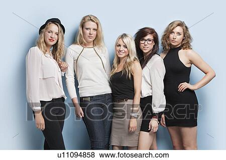 Portrait of five young female friends standing together against light blue background View Large Photo Image Stock Photo - Portrait of five young female friends standing together against light blue background. Fotosearch