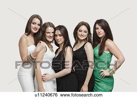 Stock Photograph - Portrait of five young women posing together over gray background. Fotosearch