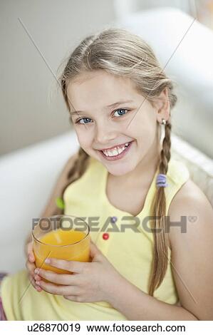 Portrait of girl drinking orange juice View Large Photo Image Stock Photo - Portrait of girl drinking orange juice. Fotosearch
