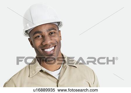 Portrait of happy African construction over with hardhat over gray background View Large Photo Image Stock Photography - Portrait of happy African construction over with hardhat over gray background. Fotosearch