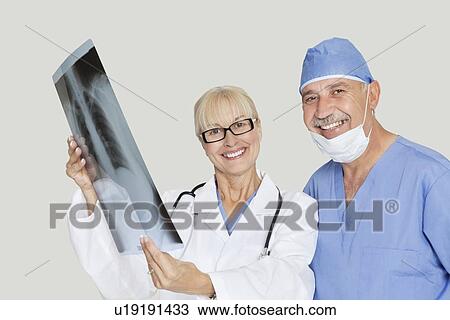 Portrait of happy medical colleagues with radiograph over gray background View Large Photo Image Stock Image - Portrait of happy medical colleagues with radiograph over gray background. Fotosearch