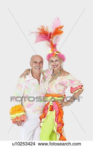Picture - Portrait of happy senior dance couple in Brazilian outfits over gray background. Fotosearch
