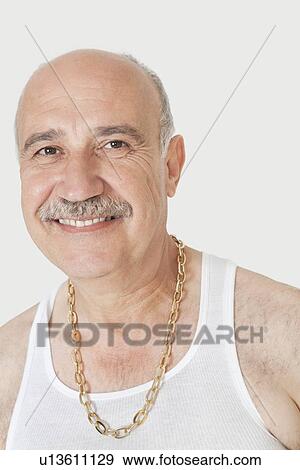 Portrait of happy senior man with gold chain over gray background View Large Photo Image Stock Photo - Portrait of happy senior man with gold chain over gray background. Fotosearch