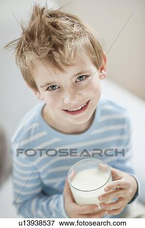 Portrait of happy young boy drinking milk View Large Photo Image Stock Photo - Portrait of happy young boy drinking milk. Fotosearch