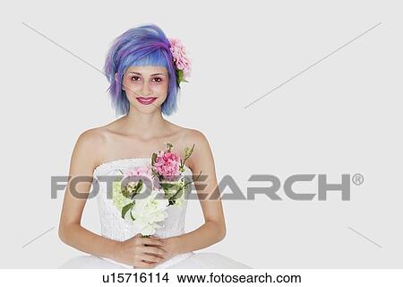 Portrait of happy young woman in wedding dress with dyed hair against gray background View Large Photo Image Picture - Portrait of happy young woman in wedding dress with dyed hair against gray background. Fotosearch