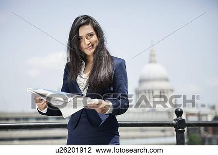 Portrait of Indian businesswoman holding newspaper with St. Paul's Cathedral in background View Large Photo Image Stock Image - Portrait of Indian businesswoman holding newspaper with St. Paul's Cathedral in background. Fotosearch