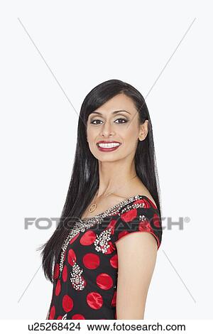 Portrait of Indian woman smiling against gray background View Large Photo Image Picture - Portrait of Indian woman smiling against gray background. Fotosearch