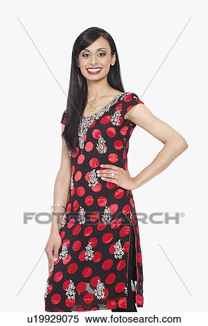 Portrait of Indian woman smiling with hand on hip against gray background View Large Photo Image Stock Photography - Portrait of Indian woman smiling with hand on hip against gray background. Fotosearch
