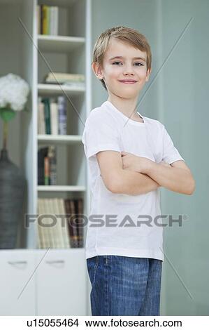 Portrait of little boy in casuals standing with arms crossed at home View Large Photo Image Picture - Portrait of little boy in casuals standing with arms crossed at home. Fotosearch