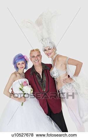 Stock Photo - Portrait of man with senior showgirl and daughter in wedding dress over gray background. Fotosearch