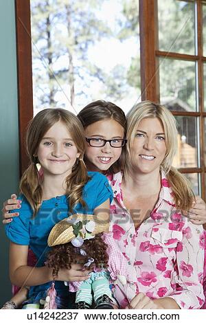 Portrait of mother and daughters smiling View Large Photo Image Stock Photo - Portrait of mother and daughters smiling. Fotosearch