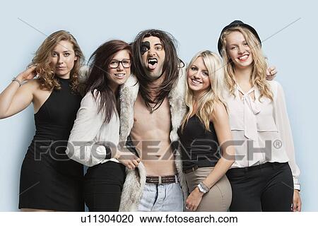 Portrait of playboy and happy women standing together against light blue background View Large Photo Image Stock Image - Portrait of playboy and happy women standing together against light blue background. Fotosearch