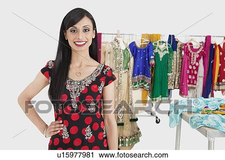 Portrait of pretty Indian female dressmaker standing with hand on hip View Large Photo Image Stock Image - Portrait of pretty Indian female dressmaker standing with hand on hip. Fotosearch
