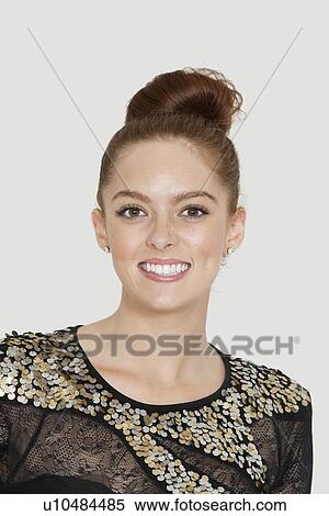 Stock Photography - Portrait of pretty young woman smiling over colored background. Fotosearch