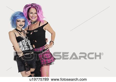 Portrait of punk females standing with arms around over gray background View Large Photo Image Stock Photo - Portrait of punk females standing with arms around over gray background. Fotosearch