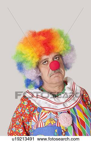 Portrait of sad senior male clown against colored background View Large Photo Image Stock Image - Portrait of sad senior male clown against colored background. Fotosearch