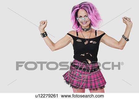 Portrait of senior female punk with raised arms over gray background View Large Photo Image Stock Image - Portrait of senior female punk with raised arms over gray background. Fotosearch
